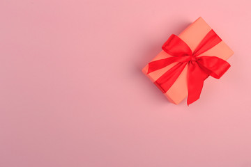 Gift box with ribbon and bow on color background and space for text. Top view - Image