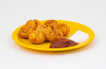 Fried Momos is a Traditional Dumpling Food From Nepal Served with Schezwan Sauce & Cream