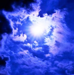 The blue sky and bright rays of the sun Shine through the fluffy clouds. Background for design and creativity-abstract unique variety-natural water vapor.