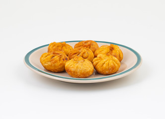 Fried Momos is a Traditional Dumpling Food From Nepal Served with Schezwan Sauce & Cream