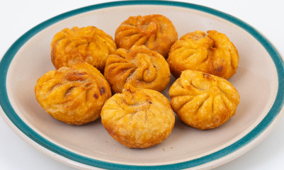 Fried Momos is a Traditional Dumpling Food From Nepal Served with Schezwan Sauce & Cream