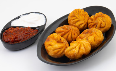 Fried Momos is a Traditional Dumpling Food From Nepal Served with Schezwan Sauce & Cream