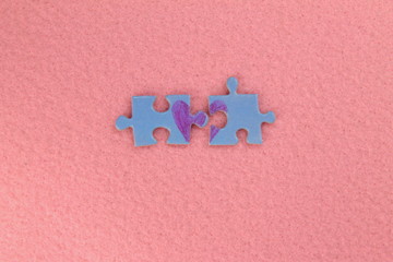 Puzzle with a red heart on the pink felt background. Valentine's day stock photo with empty space...
