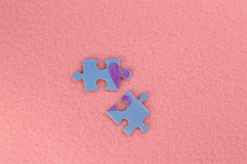 Puzzle with a red heart on the pink felt background. Valentine's day stock photo with empty space...