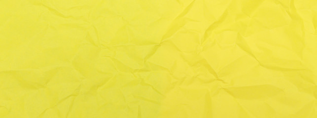 Crumpled paper texture background of yellow colour. Old empty office sheet. Creative minimal flat lay. View from above. Blank for the designer, a hat for sites.