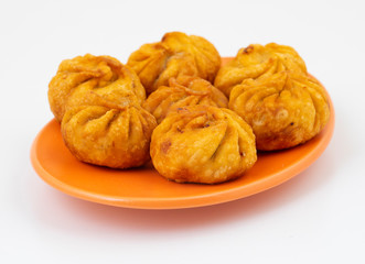 Fried Momos is a Traditional Dumpling Food From Nepal Served with Schezwan Sauce & Cream