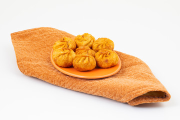 Fried Momos is a Traditional Dumpling Food From Nepal Served with Schezwan Sauce & Cream