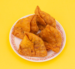 Indian Street Food Samosa or Samosas is a Crispy And Spicy Triangle Shape Snack Which Has Crisp Outer Layer of Maida & Filling of Mashed Potato, Peas And Spices. Served With Chutney, Ketchup or Curd