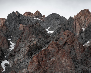 close views of the rocky heights of the mountain range under the snow - 314422139