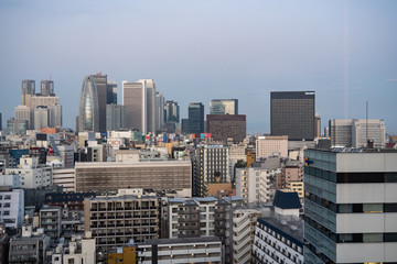 Fototapeta premium Japan / Tokyo - October 30 2019: Shinjuku skyscraper skyline building top view in the morning. Japan city urbanscape real estate.