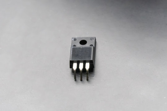 Power transistor close up on black background with copy space