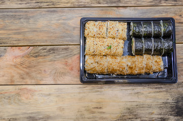 Set sushi Toto Maki, Bonito Maki, Akito Maki on a wooden background. Top view with copy space