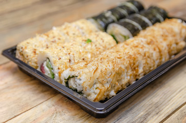 Set sushi Toto Maki, Bonito Maki, Akito Maki on a wooden background. Top view, side view