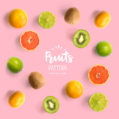 Pattern with kiwi, lime and grapefruit. Tropical abstract background. Kiwi, lemon and grapefruit on the pink background.