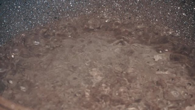 Boiling water. A boiling water in pot slowmotion