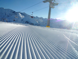 empty ski track with chairlift and skiers with copy space for your text