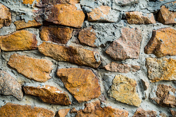 The texture of the old masonry. Background image of a stone-lined wall