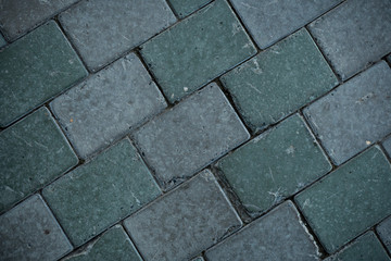 Texture of paving slabs overgrown with grass. Background image of a stratum stone