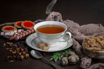 Tea hot drink on old background in composition on the table