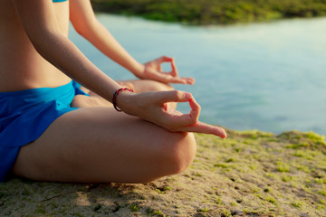 Yoga lifestyle. Close up gyan mudra. Young woman meditating, practicing yoga and pranayama with...