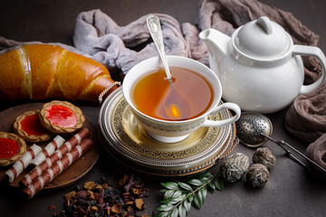 Tea hot drink on old background in composition on the table
