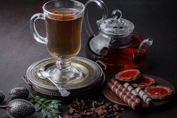 Hot tea in a cup with kitchen accessories 