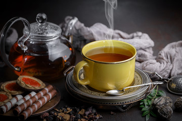 Tea hot drink on old background in composition on the table