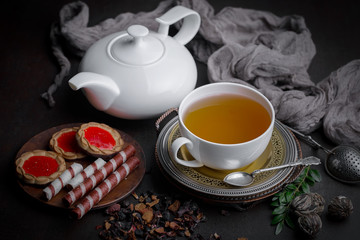 Tea hot drink on old background in composition on the table