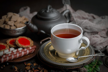 Obraz na płótnie Canvas Tea in a cup on an old background
