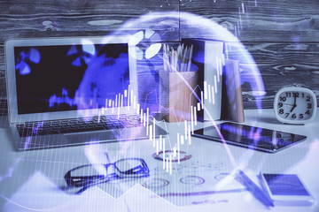 Double exposure of graph and financial info and work space with computer background. Concept of international online trading.