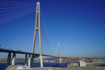 Landscape with a view of the Russian bridge against the blue sky.