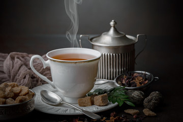 Tea hot drink on old background in composition on the table