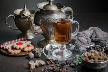 Tea hot drink on old background in composition on the table