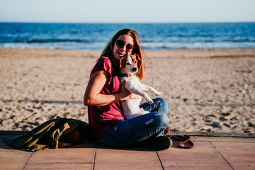 happy woman and her cute cute sitting at the beach