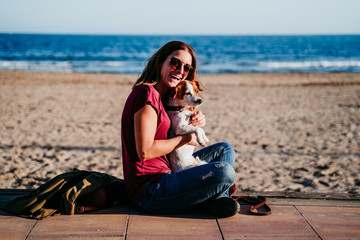 happy woman and her cute cute sitting at the beach