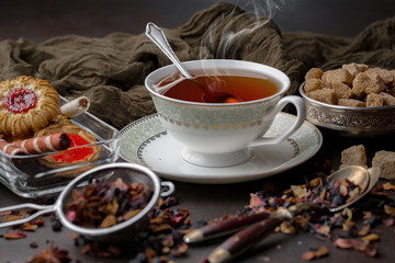Tea hot drink on old background in composition on the table