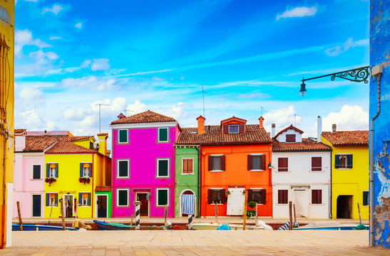 Colorful houses in Burano island with cloudy blue sky near Venice, Italy. Popular and famous tourist place © Nikolay N. Antonov