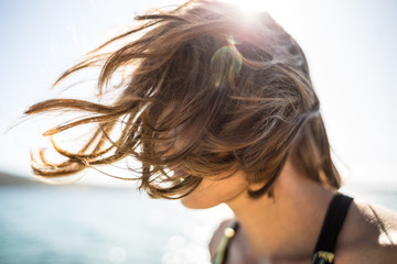 Hair blows in the wind.