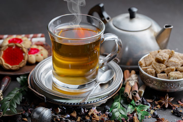 Tea hot drink on old background in composition on the table