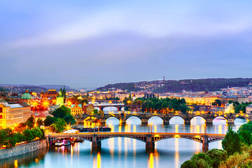 Prague at twilight sunset. Evening cityscape view of bridges on Vltava