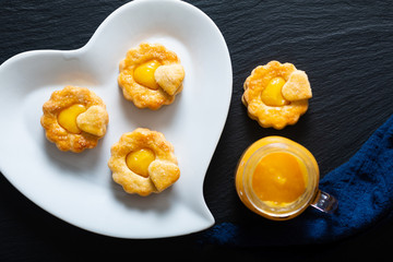 Valentine Holiday food idea concept homemade organic rustic lemon curd shortbread cookies on black background