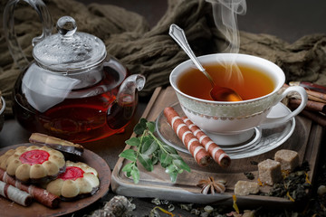 Tea hot drink on old background in composition on the table