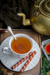 Tea hot drink on old background in composition on the table
