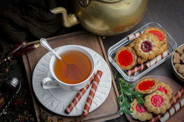 Tea hot drink on old background in composition on the table