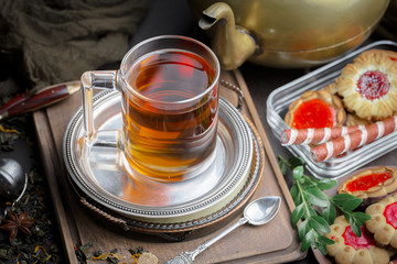 Tea hot drink on old background in composition on the table
