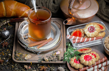 Tea hot drink on old background in composition on the table