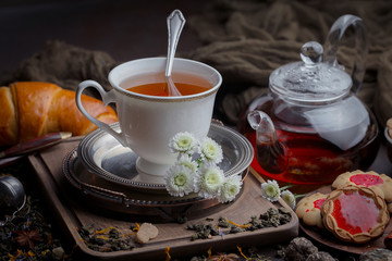 Tea hot drink on old background in composition on the table