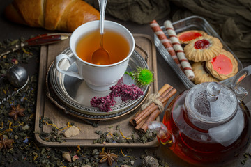 Tea hot drink on old background in composition on the table