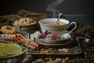 Tea hot drink on old background in composition on the table