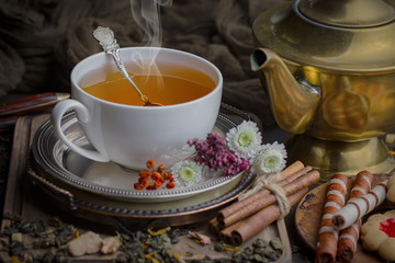 Tea hot drink on old background in composition on the table